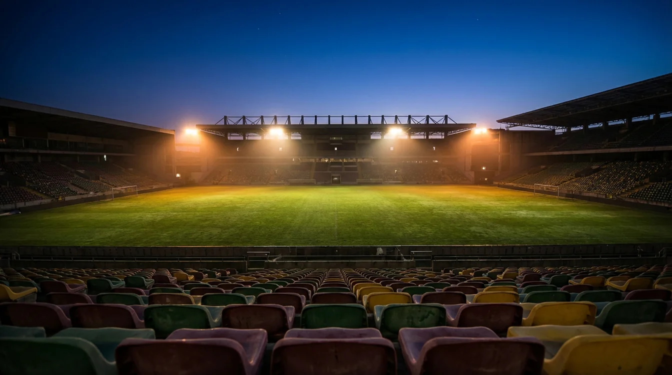Estádio de futebol português iluminado à noite com apostas desportivas